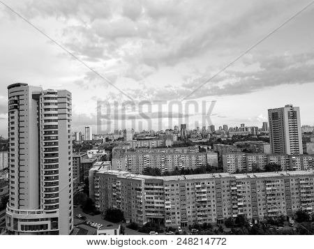 Monochrome Aerial View Of One Skyscraper And Old Long Building In The City With Sky And Clouds On Ho