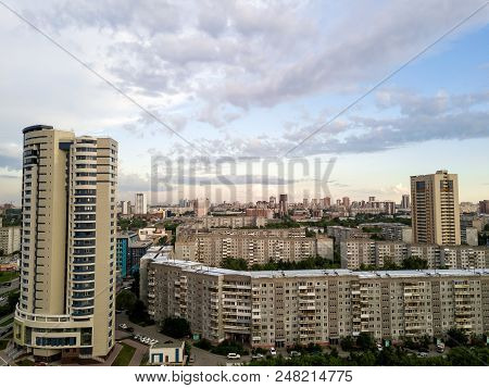 Aerial View Of One Skyscraper And Old Long Building In The City With Blue Sky And Clouds On Horizont