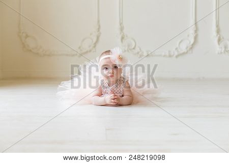 Baby Girl Wearing A Peach Tutu. Cute Girl