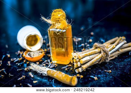 Close Up Of Effective Home Remedy For Toothache Or Tooth Sensitivity Or Erosion: Clove Oil With Blac