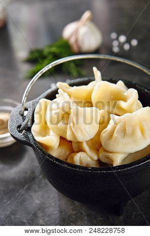 Dumplings Jiaozi, Dimsum, Momo or Ha Gao on Dark Background. Asian Food of Dough Based on Flour Stuffed with Meat, Fish, Vegetables, or Sweets