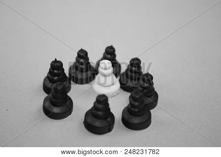Discrimination, Harassment, Middle Class Defense, Extremism Concept. Chess Pawn Pieces Grey Photo.
