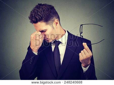 Young Business Man With Glasses Suffering From Eyestrain