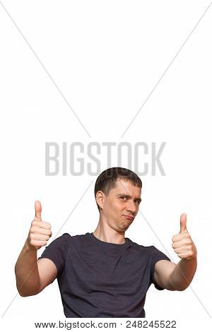 Positive Young Caucasian Man With A Funny Foolish Face, Dressed In Casual Clothes, Giving A Thumbs U