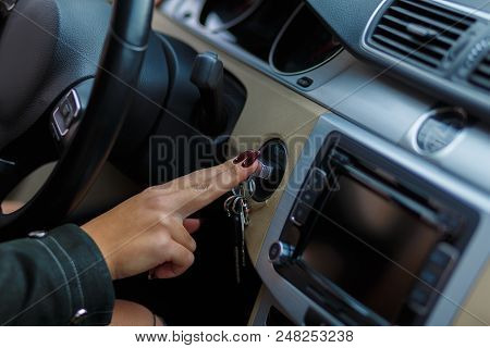 A Girl Inserts The Ignition Key, Sitting In Her Car, Ready To Start The Movement.