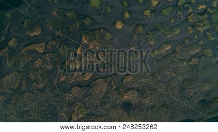 Aerial View Of River In Black Sand With Many Junctions Drone