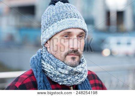 Close Up Of White Male In City. Portrait Of White Guy On Street. Bearded Man In Winter Hat And Red J