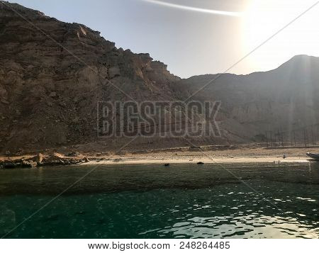 Landscape Of Clear Blue Natural Sea Salt Water, Sea, Ocean With A Bottom Of Coral Reefs, Stones Agai