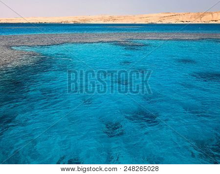 Landscape Of Clear Blue Natural Sea Salt Water, Sea, Ocean With Waves With A Bottom Of Beautiful Cor