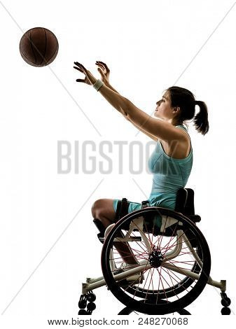 one caucasian young ped basket ball player woman in wheelchair sport tudio in silhouette isolated on white background