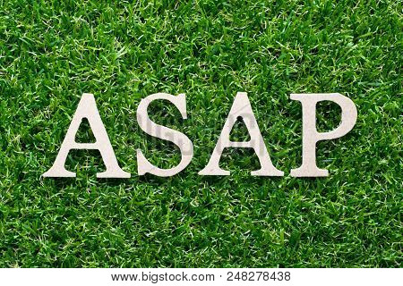 Wood Alphabet In Word Asap (abbreviation Of As Soon As Possible) On Artificial Green Grass Backgroun