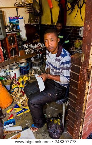 Johannesburg, South Africa, April 24, 2013, Man Making Shoes And Sandlas At Traditional Medicine Mar
