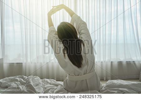 Back Side Of Asian Woman In Bathrope Suit When Waking Up From The Bed In Luxury Hotel In Morning, Li