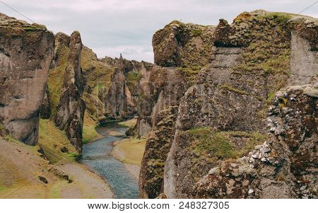 Fjadrargljufur Canyon In Iceland With Blue Water And Cloudy Sky. Really Beautiful Canyon No People