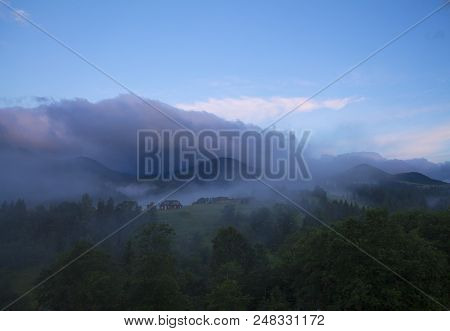 Photo Of Misty Morning Fog At The Sunrise In The Mountains. Ukraine, Carpathians, Dzembronia Village