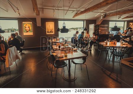 Stockholm, Sweden - Jun 16, 2018: People Eating Food In Restaurant With Water View, In The Cultural 