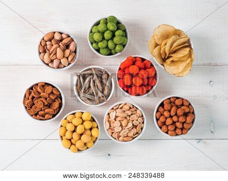 Assortment Of Different Snack For Beer, Wine, Party. Peanuts In Coconut Glaze, Green Vasabi, Red Spi