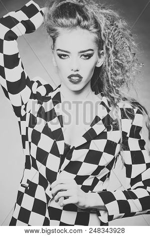 Fashionable Outfit. Portrait Of Attractive Radiant Looking Blond Young Woman With Fly-away Wavy Long