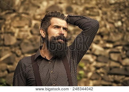 Male Revelation. Closeup View Of One Handsome Senior Man With Black Hair And Long Lush Beard In Blue