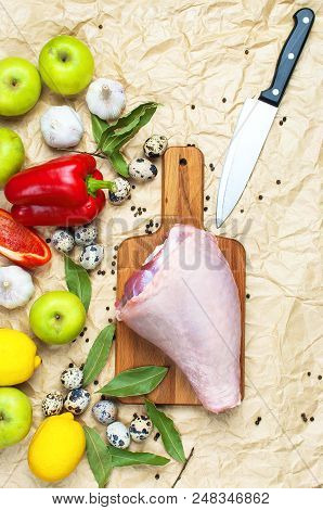 Raw Turkey Thigh Garlic Apples Lemon Red Bell Pepper Quail Eggs Spices On A Wooden Board. Top View O