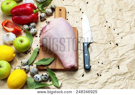 Raw Turkey Thigh Garlic Apples Lemon Red Bell Pepper Quail Eggs Spices On A Wooden Board. Top View O