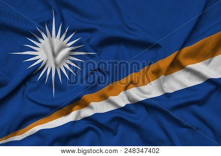Marshall Islands Flag  Is Depicted On A Sports Cloth Fabric With Many Folds. Sport Team Waving Banne