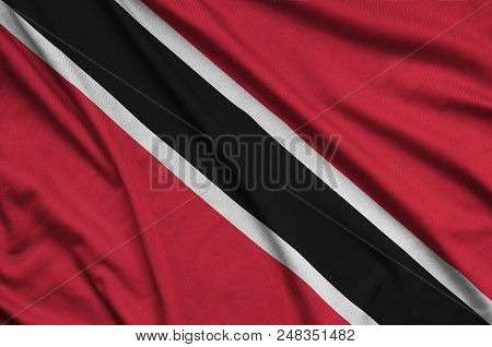 Trinidad And Tobago Flag  Is Depicted On A Sports Cloth Fabric With Many Folds. Sport Team Waving Ba