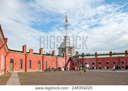 Saint-petersburg, Russia - July 4, 2018: People In Peter And Paul Fortress Next To The Flag Pole Tow