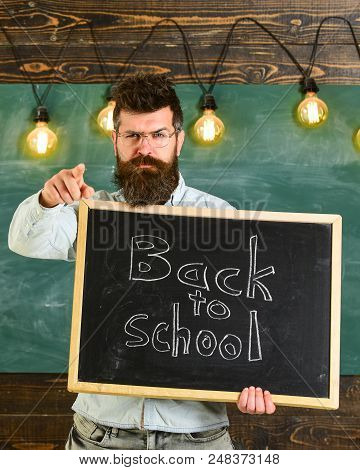 Back To School Concept. Teacher In Eyeglasses Holds Blackboard With Inscription Back To School. Man 