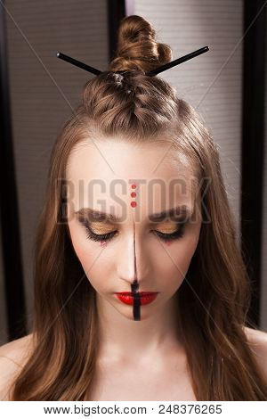Beautiful Young Girl Model With Professional Unusual Mystic Makeup And A Coiffure With Topknot And B