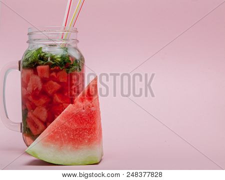 Watermelon Smoothie With Slice Of Fruit And Leaf Of Mint Over Pink Background, Copy Space, Close Up.