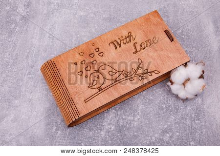 A Carved Wooden Casket With Cute Images Is Decorated With Pussy-willow, Lying On The Grey Background