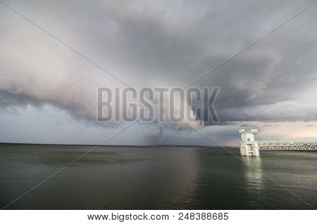 A Supercell Thunderstorm And Shelf Cloud Loom Over A Lake. All Boats Have Left The Water Because Of 