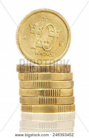 Stack Of Swedish Golden 10 Krona Coins On White Background.