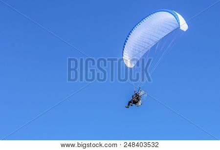 Skydiver, Hovering In The Sky On A Parachute With A Motor