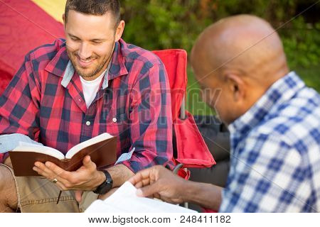 Men Having A Bible Study On A Camping Trip.