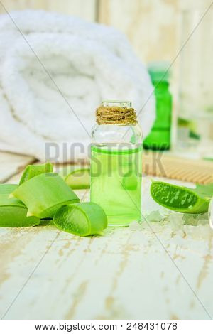 Aloe Vera Extract In A Small Bottle And Pieces On The Table. Selective Focus.