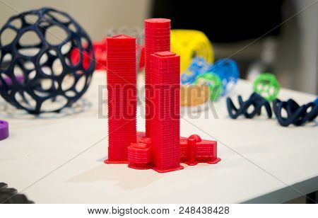 Abstract Object Of A Red Color Printed On A 3d Printer On A White Table. Fused Deposition Modeling, 