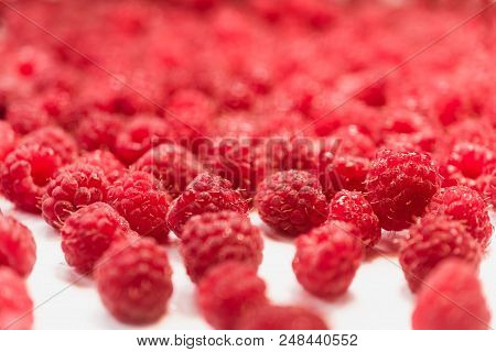 Dripping Raspberry On White Background. Close-up Photo.
