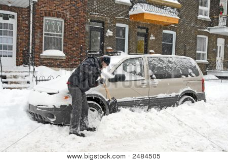 Man Shovelling And Removing Snow