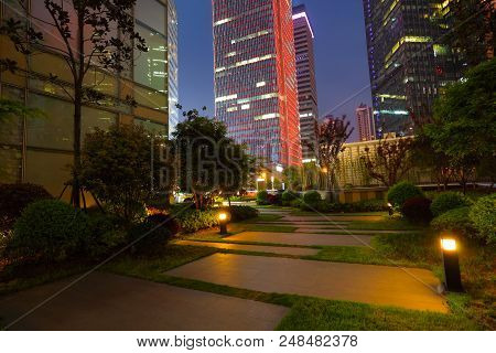 Empty Marble Road Surface With City Buildings Of Night