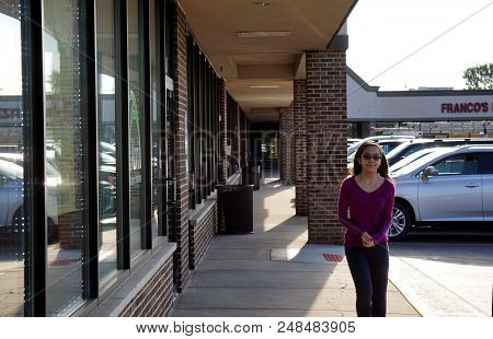 Joliet, Illinois / United States - August 7, 2017: A Girl Walks Past The Front Entrance Of The Abri 