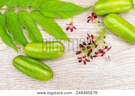 Averrhoa Bilimbi Fruit With Flowers And Leaf On Wood Background