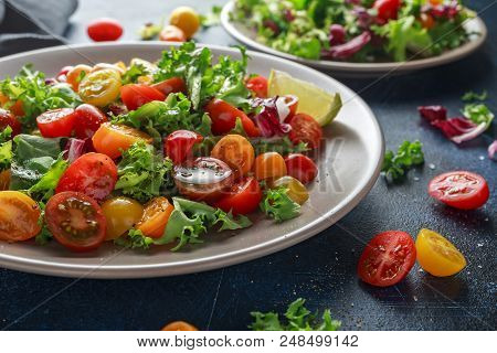 Fresh Cherry Tomato Mix Salad With Lettuce, Lemon, Lime, Black Pepper And Sea Salt. Healthy Food.
