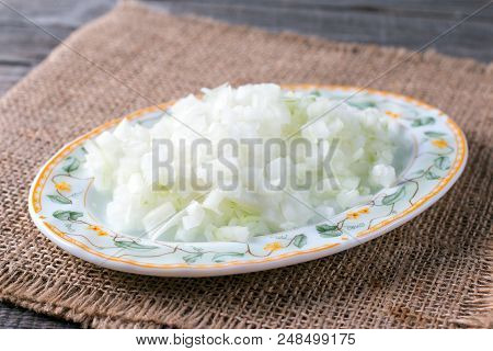 Chopped Nions On A Plate On A Wooden Table