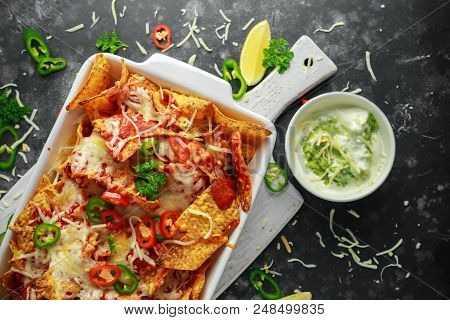 Maxican-style Tortilla Nachos Chips Topped With Tomato Salsa, Sliced Chilies And Melted Cheese Serve