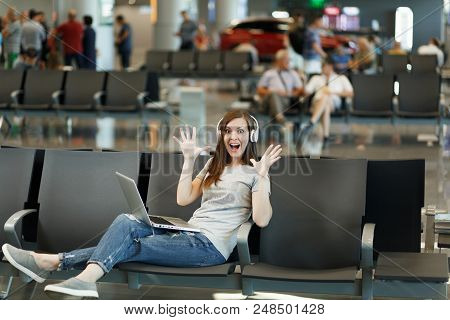 Shocked Traveler Tourist Woman With Headphones Listening Music, Working On Laptop Spreading Hands, W