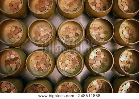 Top View Of Coins In Little Monk Bowl For Exorcise From Believe In Buddhism