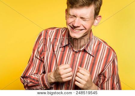 Happiness Enjoyment And Laugh. Man With A Wide Grin. Portrait Of A Young Guy On Yellow Background. E