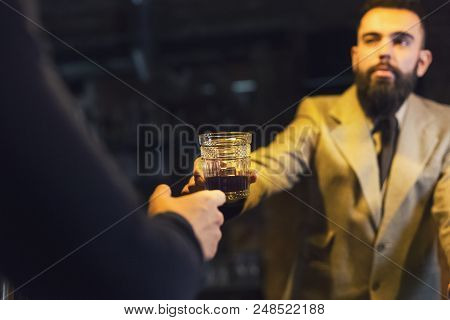 Bartender Giving Glass Of Whiskey Or Cognac To Customer In Bar, Copy Space